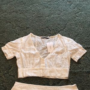 White eyelet crop top and mini skirt set.